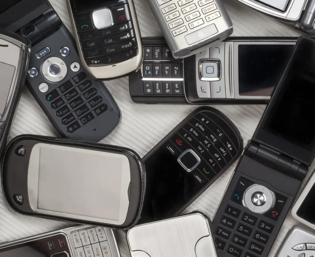 Assortment of vintage mobile phones and flip phones.