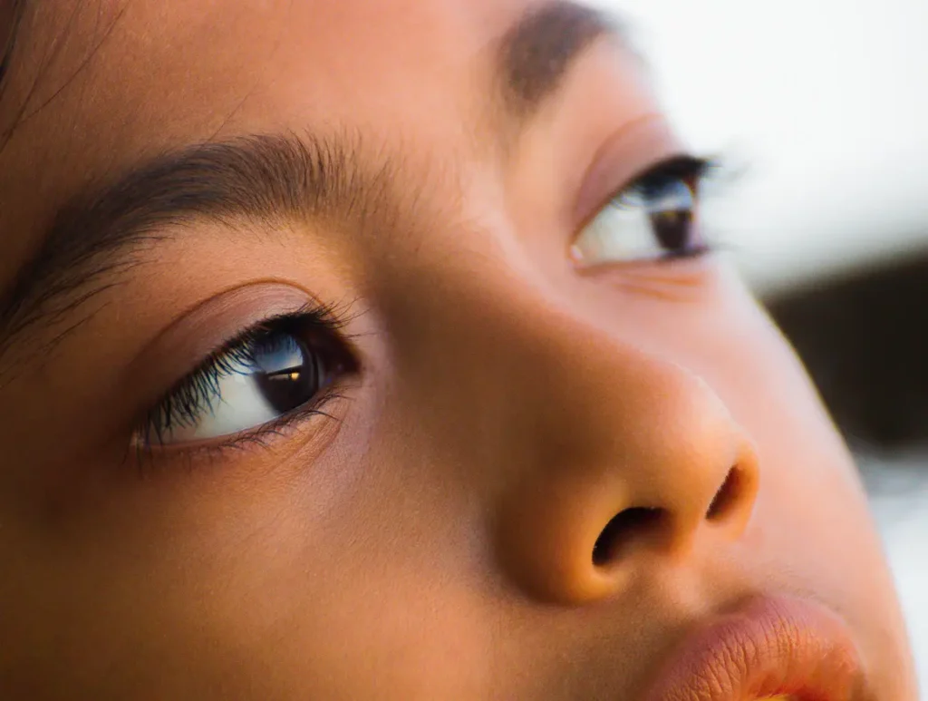 Close up of a young person's eye and nose looking upwards
