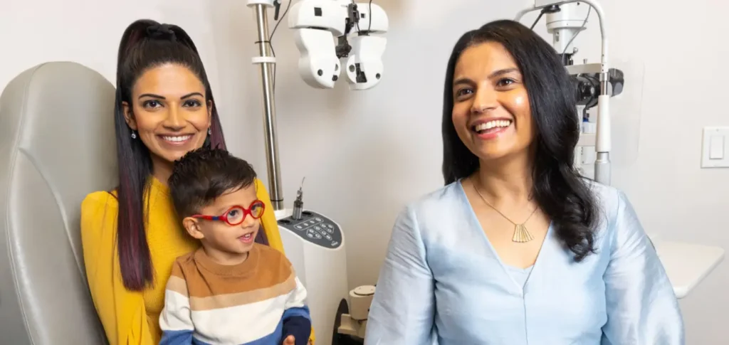 Two women and a young boy with glasses in an optometrist's office.